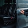 A private driver opening the door of a luxury minivan
